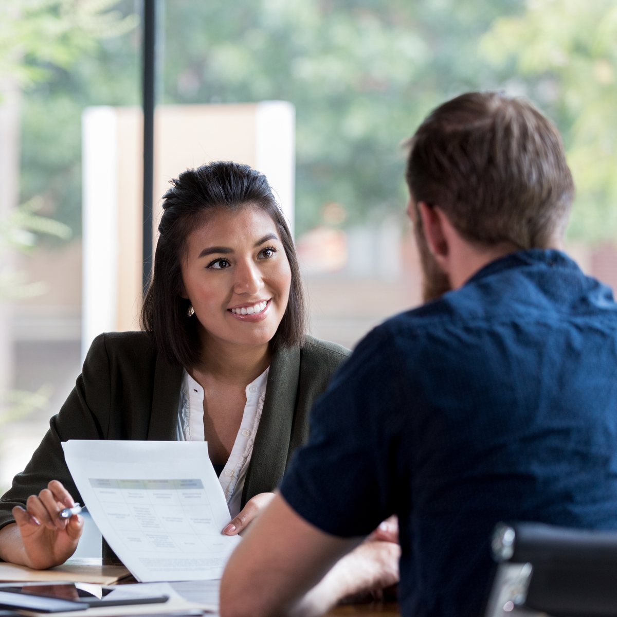 Two people in conversation over a document